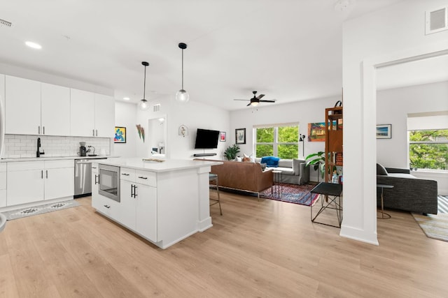 kitchen with visible vents, light wood-type flooring, open floor plan, and stainless steel appliances