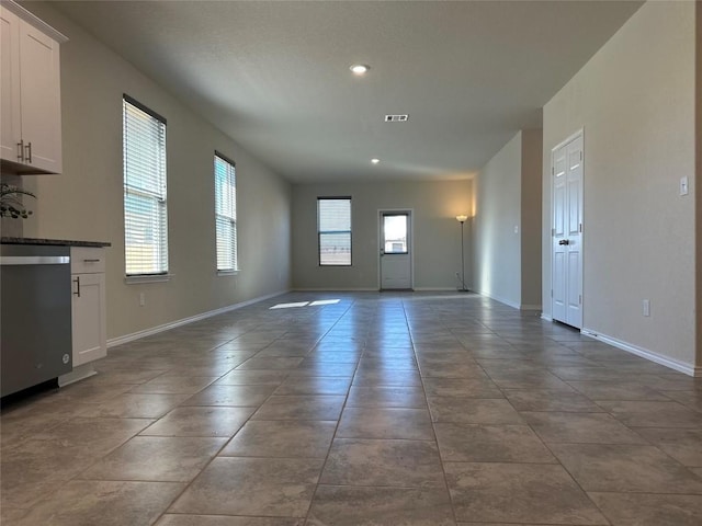 interior space with baseboards, recessed lighting, and visible vents