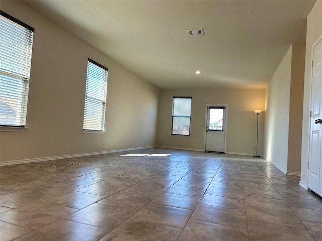 empty room with baseboards and visible vents