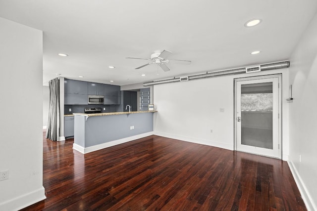 unfurnished living room featuring ceiling fan, a sink, dark wood finished floors, recessed lighting, and visible vents