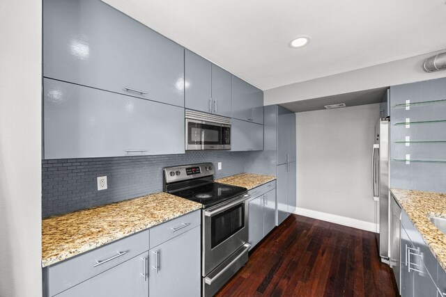 kitchen featuring baseboards, dark wood finished floors, appliances with stainless steel finishes, and gray cabinets