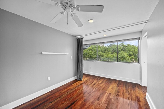 spare room with baseboards, a ceiling fan, wood finished floors, and recessed lighting