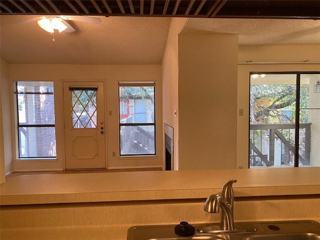 interior space with a ceiling fan and a textured ceiling