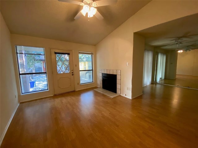 unfurnished living room with a healthy amount of sunlight, ceiling fan, and wood finished floors