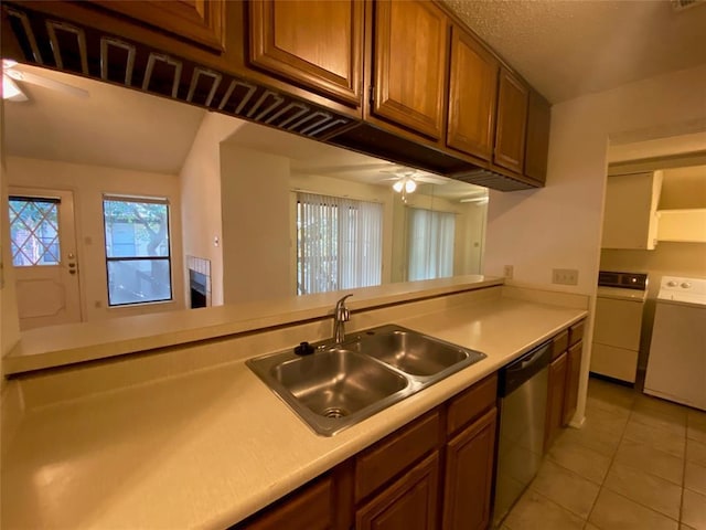 kitchen featuring ceiling fan, a sink, dishwasher, light countertops, and washer and clothes dryer