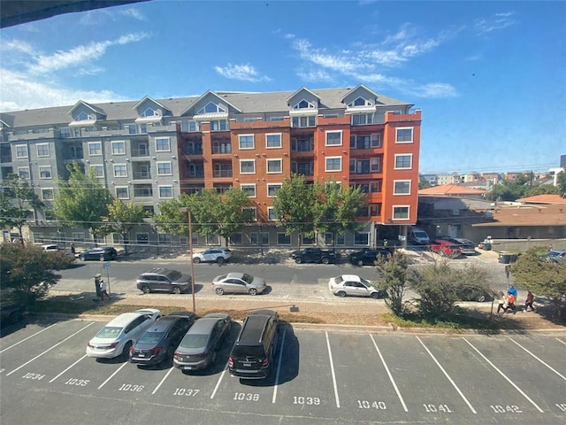 view of building exterior featuring uncovered parking