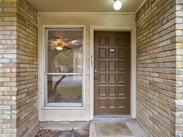 property entrance with brick siding