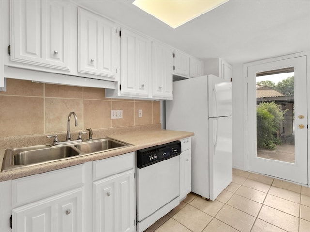kitchen featuring a sink, light tile patterned floors, white cabinets, and white appliances
