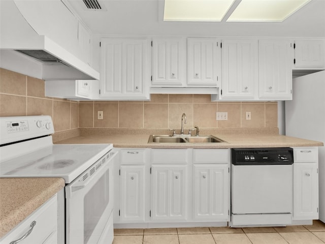 kitchen featuring a sink, premium range hood, white appliances, and light countertops