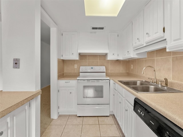 kitchen with visible vents, premium range hood, white range with electric stovetop, a sink, and dishwasher