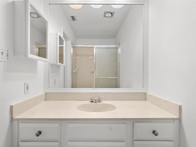8301 Summer Side Dr Unit 167, Austin, TX 78759 - full bathroom featuring vanity and a shower with shower door