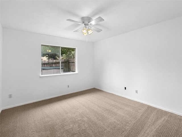 unfurnished room featuring ceiling fan, baseboards, and carpet