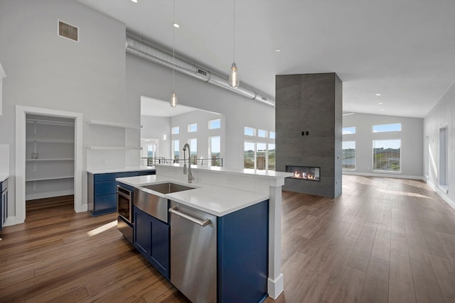 3503 Constitution Dr, Lago Vista, TX 78645 - kitchen with blue cabinets, open floor plan, dishwasher, high vaulted ceiling, and healthy amount of natural light