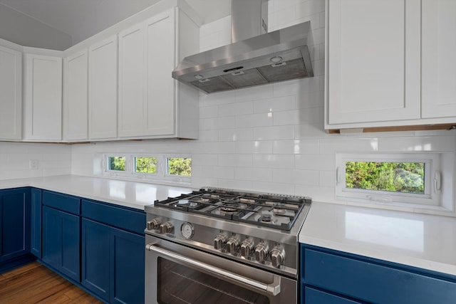 3503 Constitution Dr, Lago Vista, TX 78645 - kitchen with wall chimney range hood, high end stainless steel range oven, blue cabinets, light countertops, and tasteful backsplash