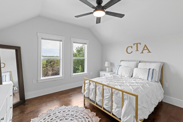bedroom featuring baseboards, a ceiling fan, vaulted ceiling, and hardwood / wood-style flooring