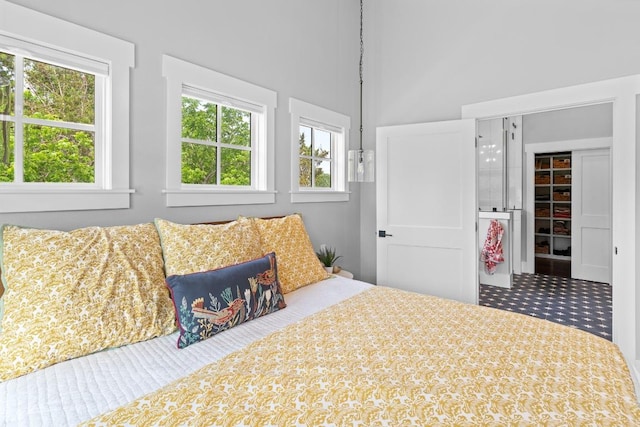 bedroom with a closet, a walk in closet, and a high ceiling