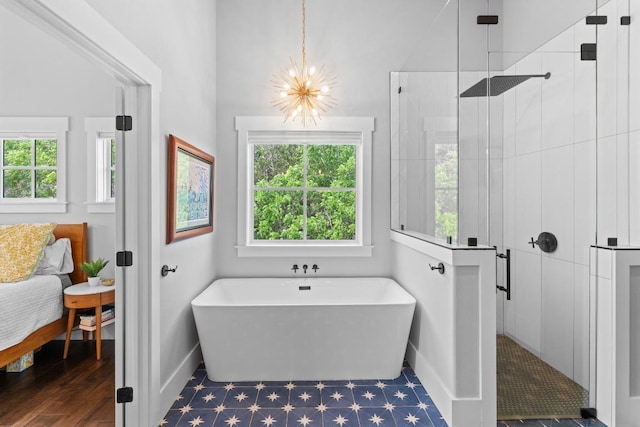 full bath featuring a chandelier, plenty of natural light, and a stall shower