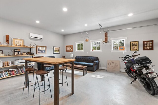 dining area featuring baseboards, an AC wall unit, recessed lighting, and concrete floors