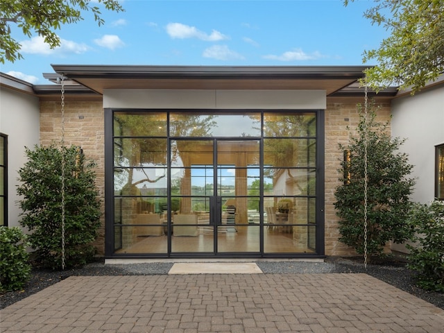 view of exterior entry with stucco siding