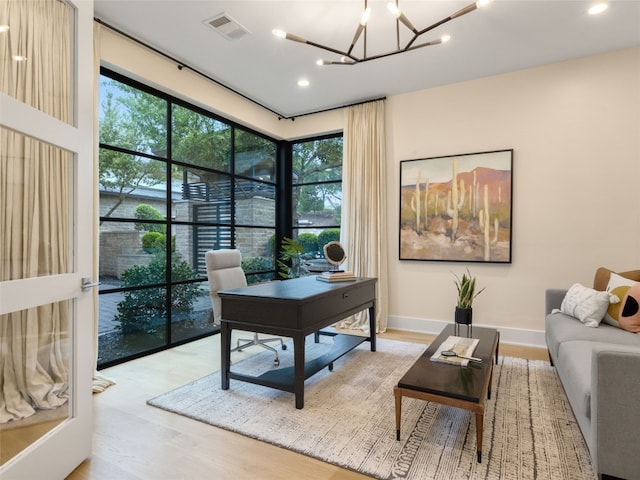 office space with visible vents, wood finished floors, baseboards, a chandelier, and recessed lighting
