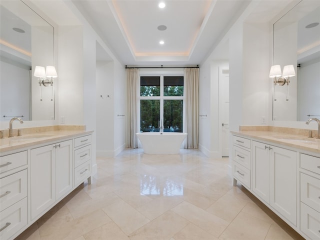 full bath with a sink, baseboards, and two vanities