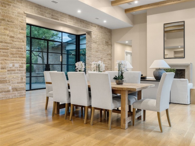 dining room with light wood-style floors, beamed ceiling, and recessed lighting