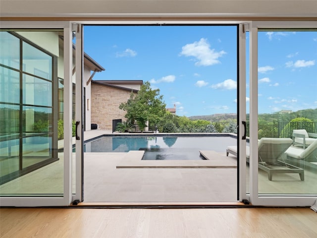 doorway to outside with wood finished floors