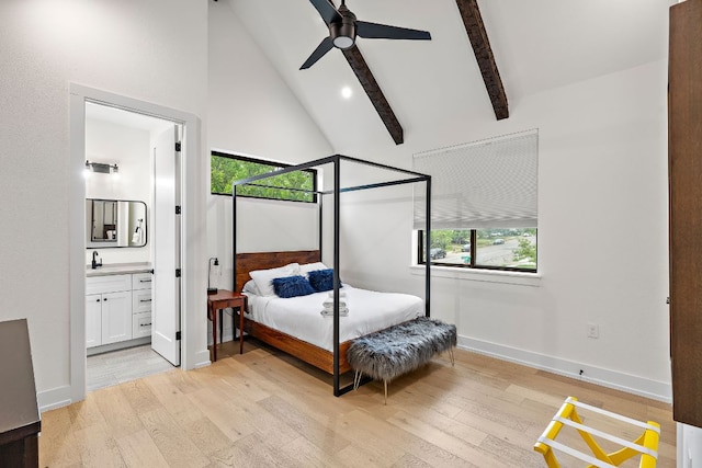 bedroom with light wood-style floors, baseboards, multiple windows, and high vaulted ceiling