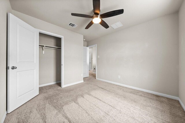 unfurnished bedroom with light colored carpet, baseboards, and visible vents