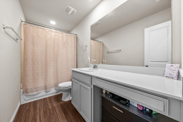 13601 Primrose Petal Dr, Manor, TX 78653 - full bathroom with toilet, vanity, wood finished floors, shower / bath combination with curtain, and recessed lighting