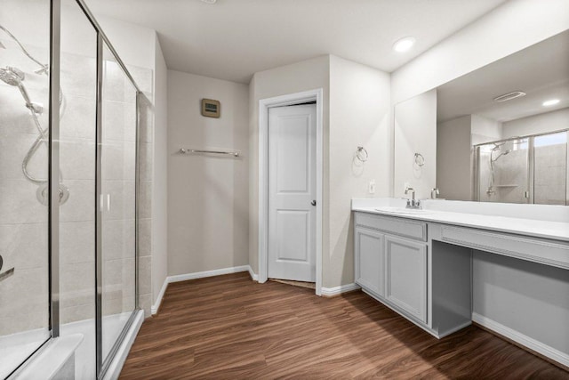 13601 Primrose Petal Dr, Manor, TX 78653 - bathroom featuring a stall shower, wood finished floors, vanity, and baseboards
