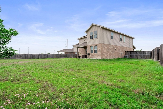 view of yard featuring central AC unit and a fenced backyard