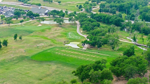 drone / aerial view featuring a water view and golf course view