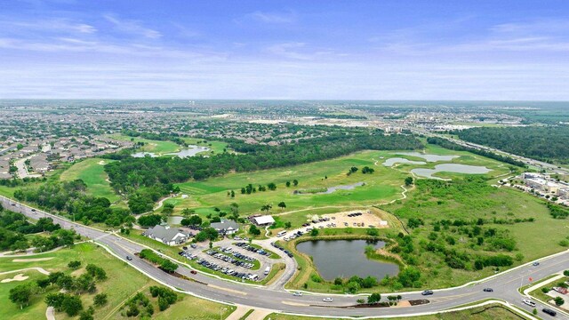 drone / aerial view featuring a water view and golf course view