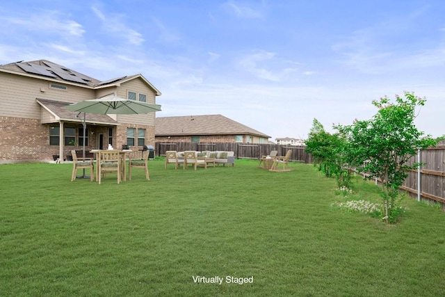 view of yard featuring a fenced backyard and an outdoor hangout area