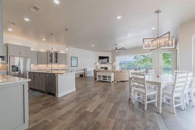 2228 Williams Lakeshore Dr, Kingsland, TX 78639 - kitchen with dark wood-style flooring, a sink, visible vents, stainless steel appliances, and gray cabinetry