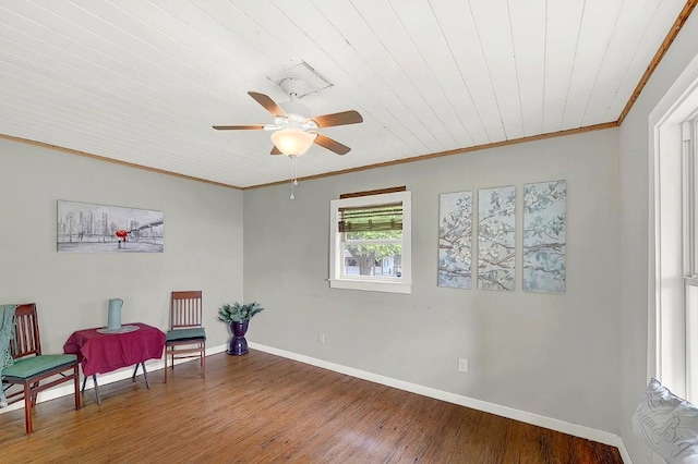 sitting room featuring a ceiling fan, crown molding, wood finished floors, baseboards, and wooden ceiling