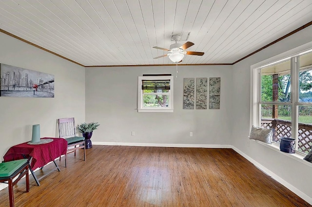 sitting room featuring a ceiling fan, wooden ceiling, baseboards, wood-type flooring, and ornamental molding