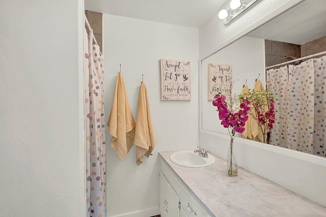 bathroom with vanity, baseboards, and a shower with curtain