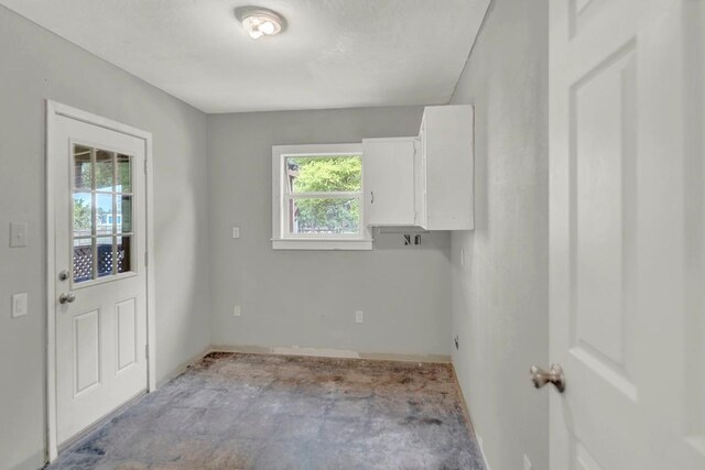 laundry area with baseboards