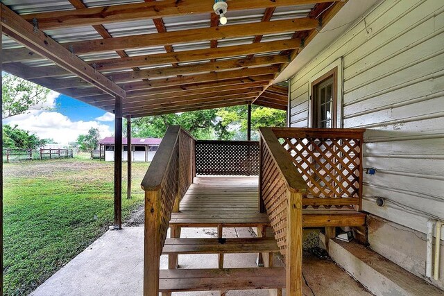 wooden terrace featuring a yard