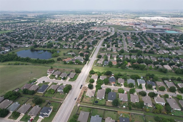 drone / aerial view featuring a residential view and a water view