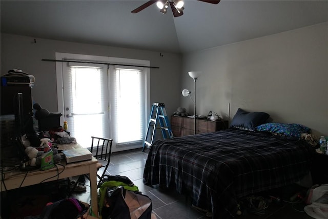 tiled bedroom with ceiling fan and vaulted ceiling