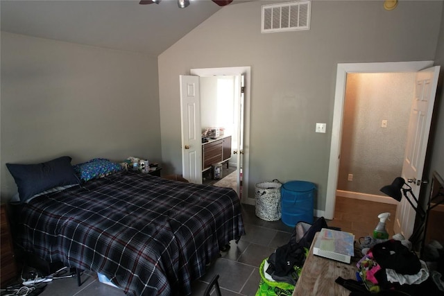 bedroom with tile patterned flooring, vaulted ceiling, and visible vents