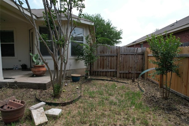 view of yard featuring fence and a patio area