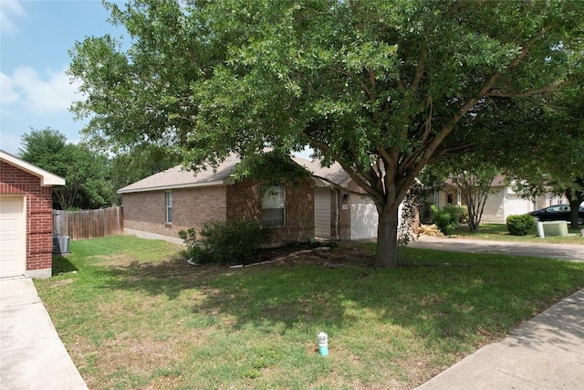 exterior space with a yard, brick siding, and fence