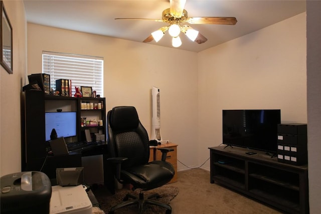 carpeted home office with ceiling fan
