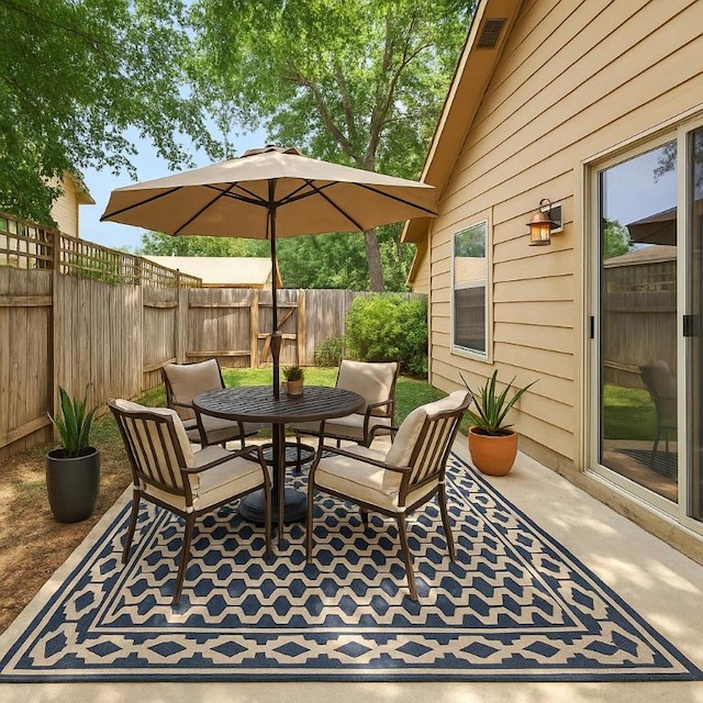 view of patio / terrace featuring outdoor dining space and a fenced backyard