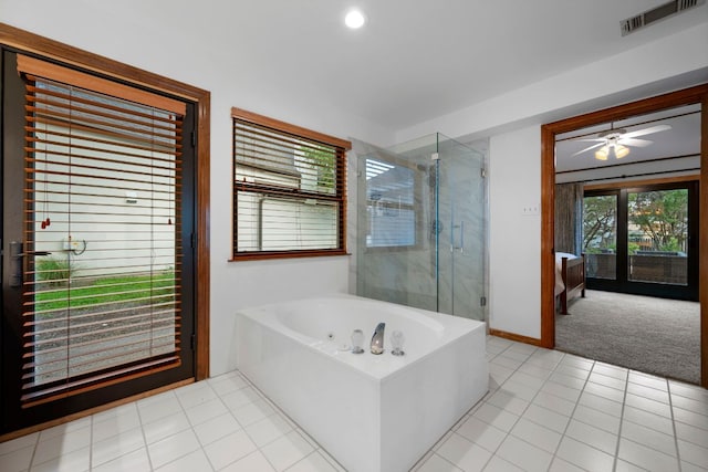 ensuite bathroom featuring a ceiling fan, a bath, visible vents, a shower stall, and baseboards