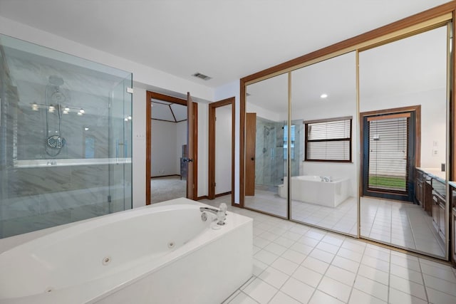 full bathroom featuring visible vents, a freestanding tub, a stall shower, vanity, and tile patterned floors